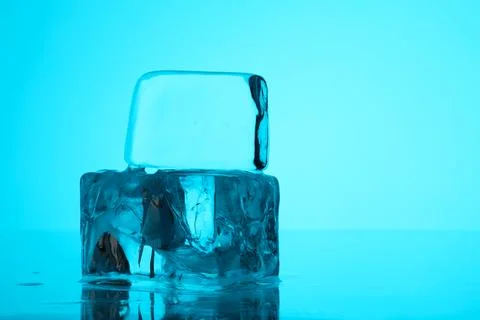 Cubes of clear ice on light blue background, closeup. Space for text Foto stock
