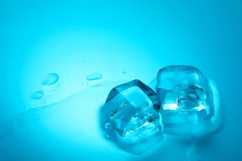 Cubes of clear ice on light blue background, closeup. Space for text 스톡 사진