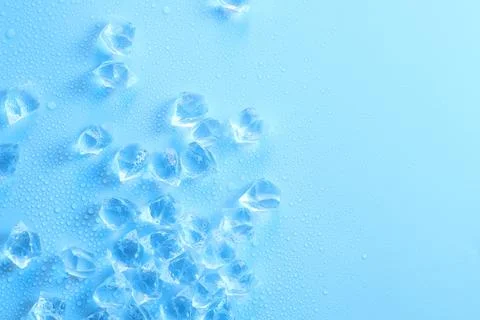 Cubes of clear ice on light blue background, flat lay. Space for text Stock Photos