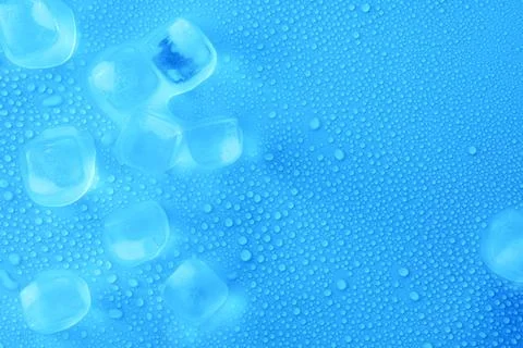 Cubes of clear ice on light blue background, flat lay. Space for text Stock Photos