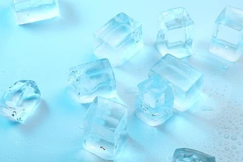 Cubes of clear ice on light blue background, closeup Foto stock
