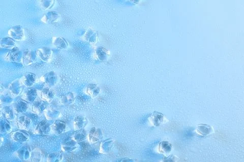 Cubes of clear ice on light blue background, flat lay. Space for text 스톡 사진