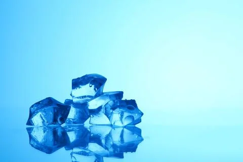 Cubes of clear ice on light blue background, closeup. Space for text Stock Photos