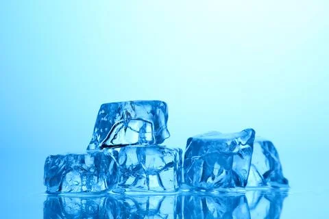 Cubes of clear ice on light blue background, closeup. Space for text 写真素材