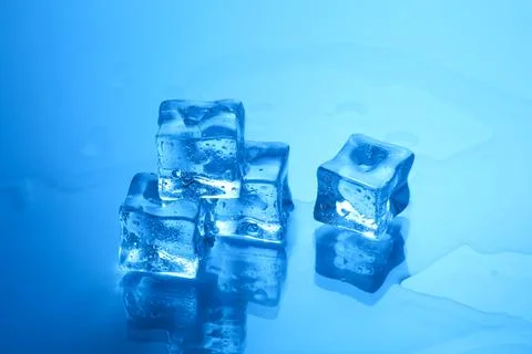 Cubes of clear ice on light blue background, closeup Stock Photos
