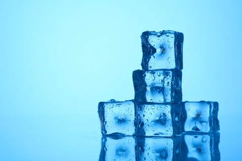 Cubes of clear ice on light blue background, closeup. Space for text Stock Photos