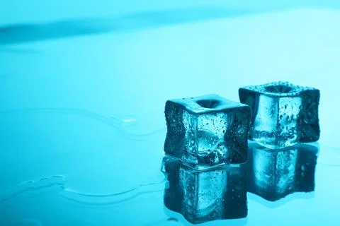 Cubes of clear ice on light blue background, space for text 스톡 사진