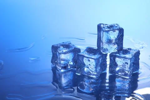 Cubes of clear ice on light blue background, space for text 스톡 사진