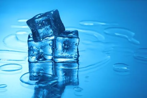 Cubes of clear ice on light blue background, space for text Stock Photos