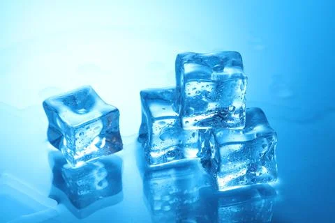 Cubes of clear ice on light blue background, closeup Stock Photos