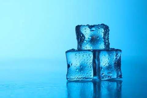Cubes of clear ice on light blue background, closeup. Space for text Stock Photos