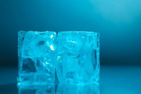 Cubes of clear ice on light blue background, closeup Stock Photos
