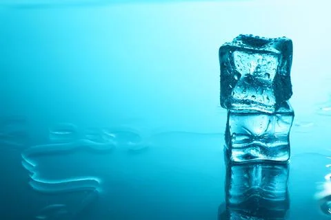 Cubes of clear ice on light blue background, space for text 스톡 사진