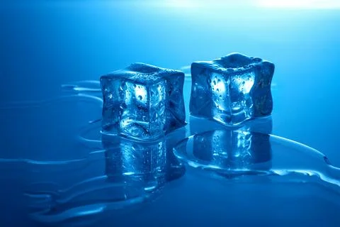 Cubes of clear ice on light blue background Foto stock