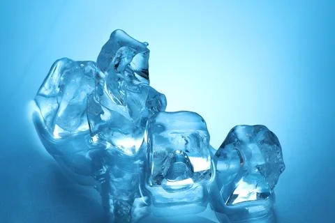 Cubes of clear ice on light blue background, closeup. Space for text Stockfoto's