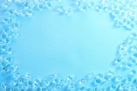 Cubes of clear ice on light blue background, flat lay. Space for text 写真素材