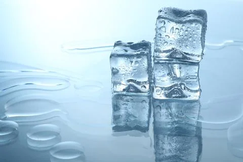 Cubes of clear ice on mirror surface, space for text Stock Photos
