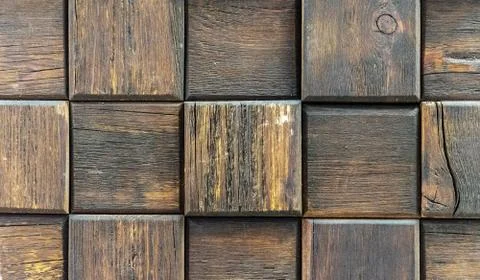 Cubes from of dark aged wood. Panel with wooden squares for wall decor. Stock Photos