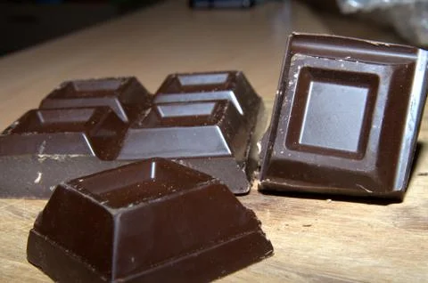 Cubes of dark chocolate Stock Photos