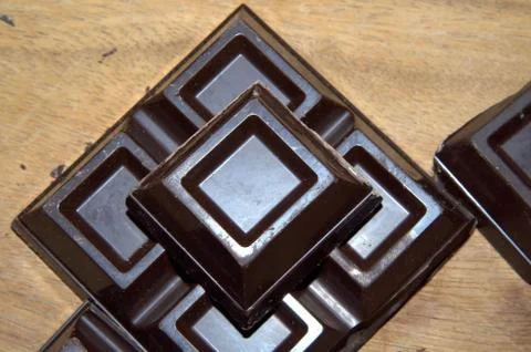 Cubes of dark chocolate Stock Photos
