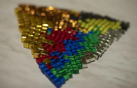 Cubes of different colors. Chips from board game. Triangle shape made of smal Foto stock