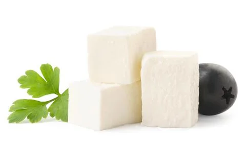Cubes of feta cheese with a leaf and an olive close-up on a white. Isolated Stock Photos