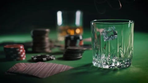 Cubes of ice slowly fall into the glass and then the whiskey or rum is poured Stock Footage 138934056