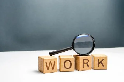 Cubes labeled work and magnifying glass. Concept of job search or workers. .. Stock Photos