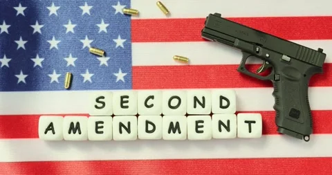 Cubes marked Second Amendment and firearm nearby on American flag Stock Footage 280572847