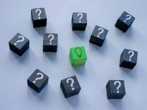 Cubes with question marks and one with a light bulb as a concept for an idea or 스톡 사진