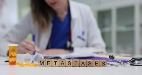 Cubes spell Metastases while doctor works on cancer diagnosis Stock Footage 314117428