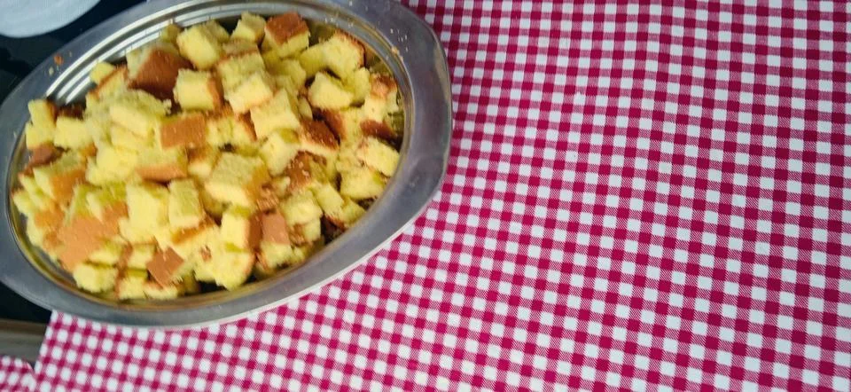 Cubes of Sponge Cake on Checkered Tablecloth 스톡 사진