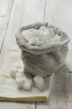 Cubes of sugar in burlap bag Stock Photos