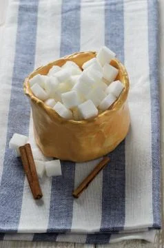 Cubes of sugar in rustic bowl Stock Photos