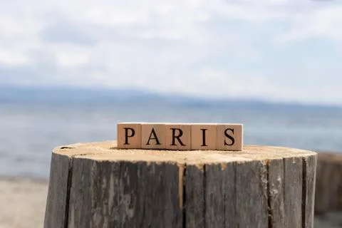 Cubes on tree stump. It says the paris on it. Close up. Stock Photos