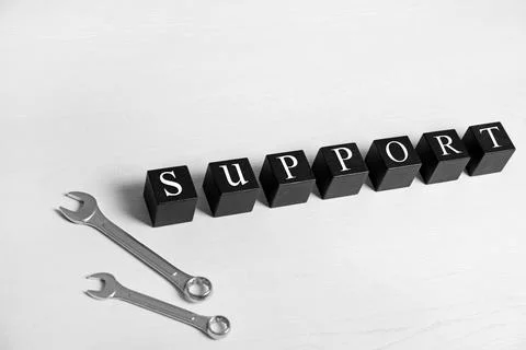Cubes with word SUPPORT and wrenches on wooden background. Technical service 写真素材