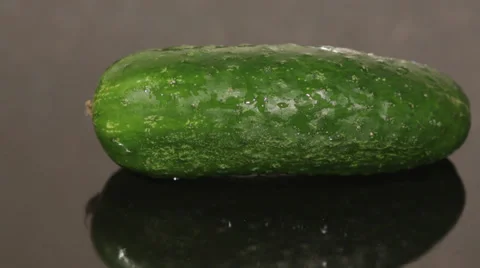 A cucumber on a black pan closeup Stock Footage 56058681