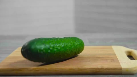 Cucumber falls on a cutting board Stock Footage 194163293