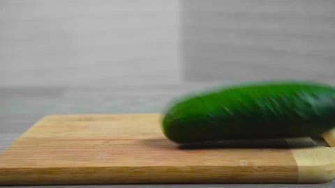 Cucumber falls on a cutting board Stock Footage 196725803