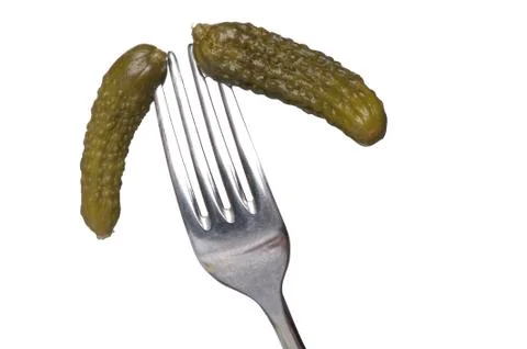 Cucumber on fork on white Stock Photos
