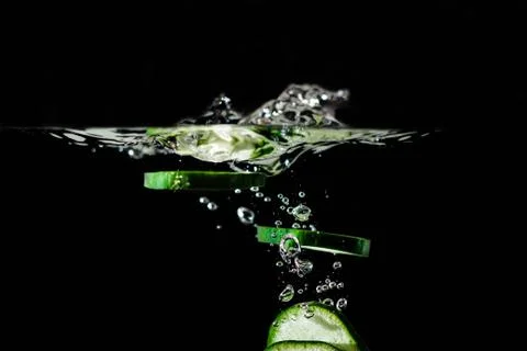 Cucumber gin vodka cocktail splashing bubbles Stock Photos