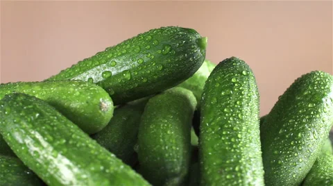 Cucumber isolated rotating on brown background Stock Footage 62405024