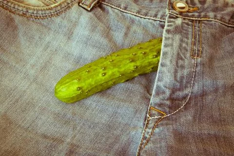 Cucumber on jeans Stock Photos