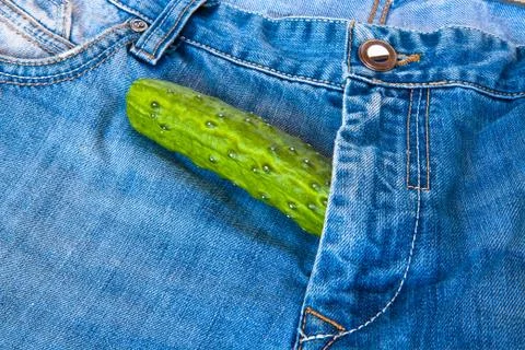 Cucumber on jeans Stock Photos