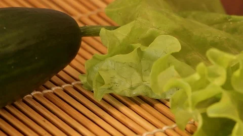 Cucumber lay near the lettuce leaf, especially close-up Stock Footage 85609971