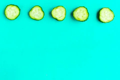 Cucumber pattern on bright blue background. Minimal concept. Copy space for t Stock Photos