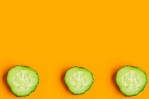 Cucumber pattern on bright orange background, minimal concept, copy space for Stock Photos
