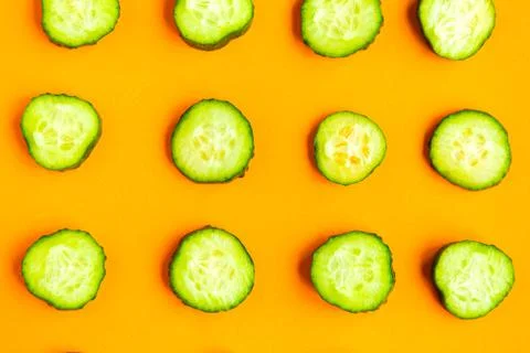 Cucumber pattern on bright orange background. Minimal concept. 写真素材