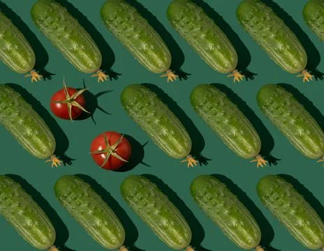 Cucumber pattern. Cucumbers on a green background. Vegetables. Stock Photos