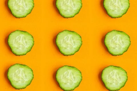 Cucumber pattern on orange background, minimal concept 스톡 사진
